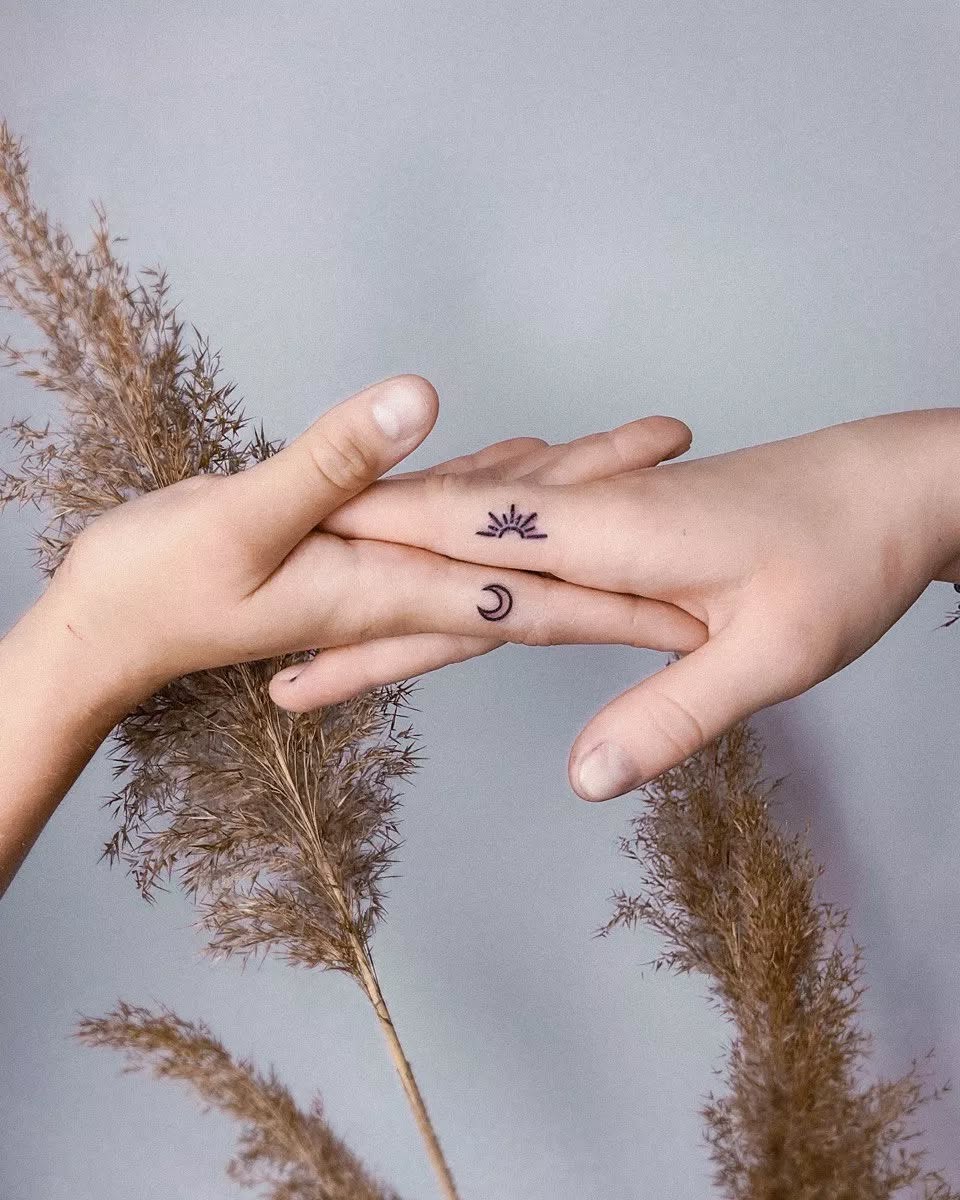 Symbolic sun and moon tattoos unite friends