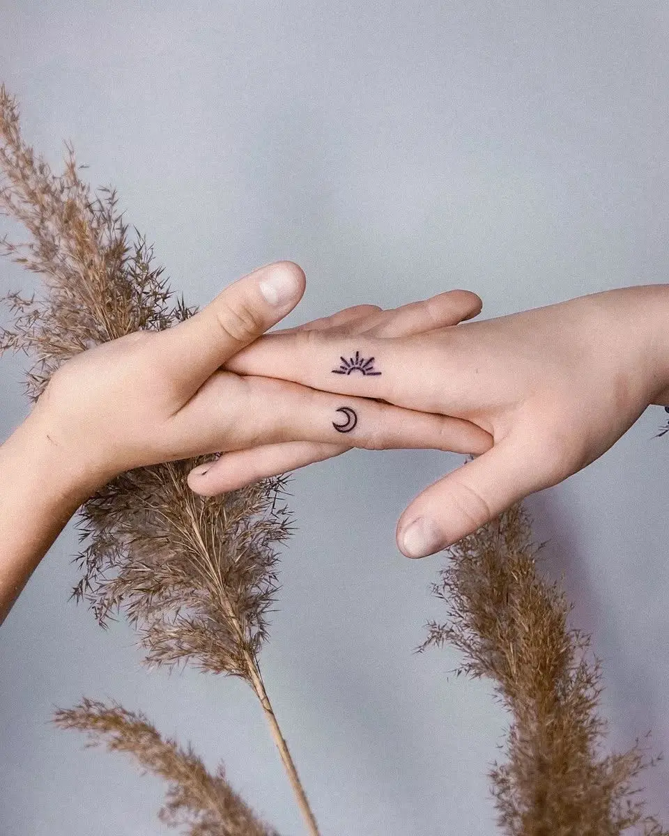 Symbolic sun and moon tattoos unite friends