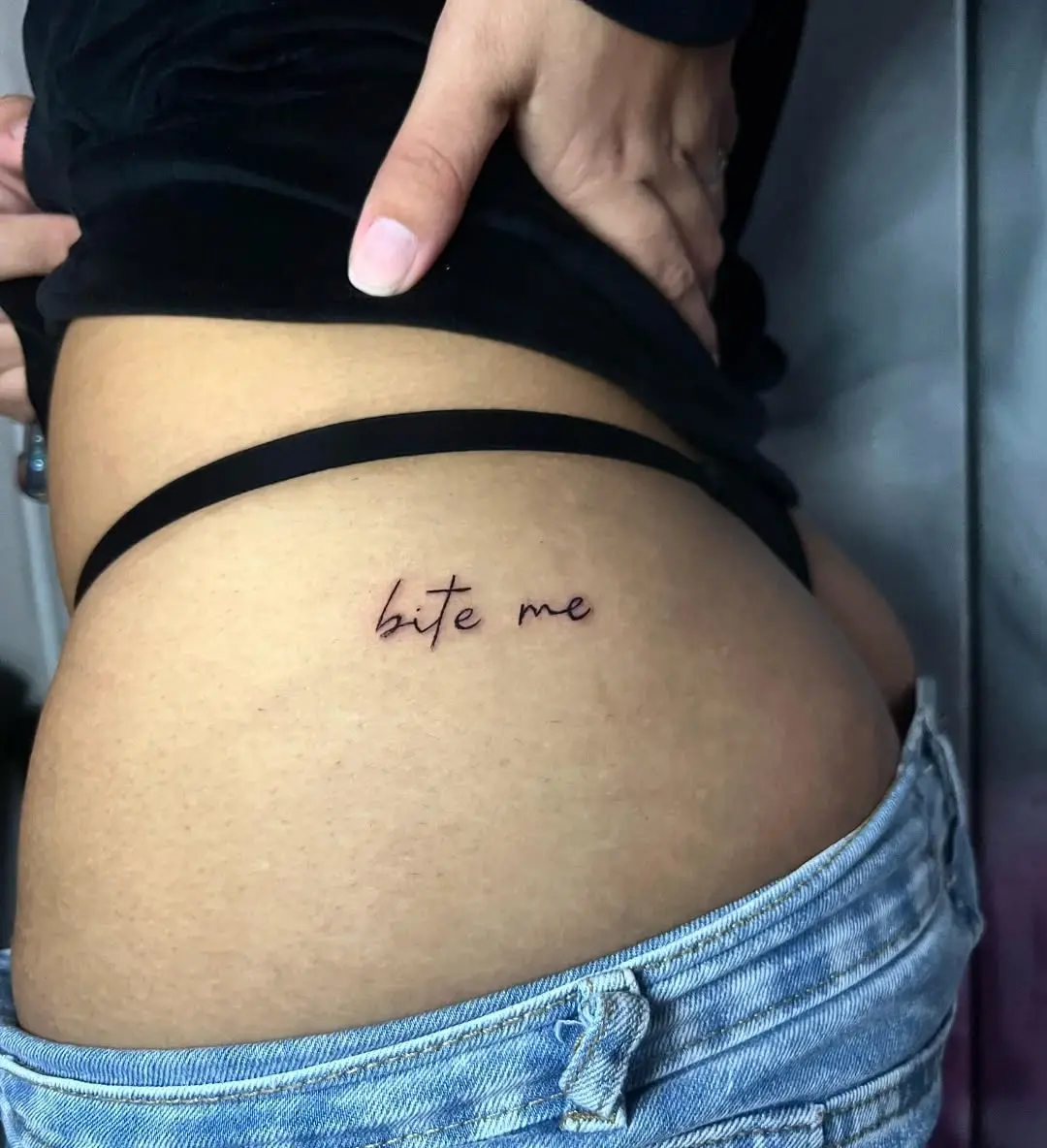 Playful lower back tattoo with attitude