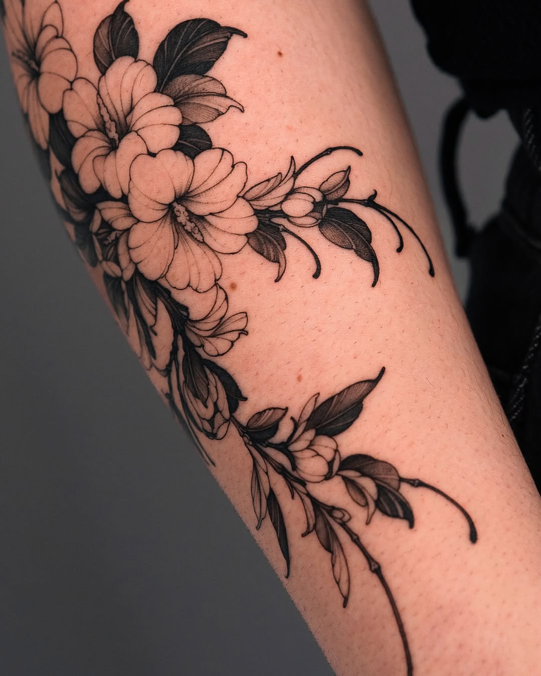 Elegant floral tattoo on the forearm