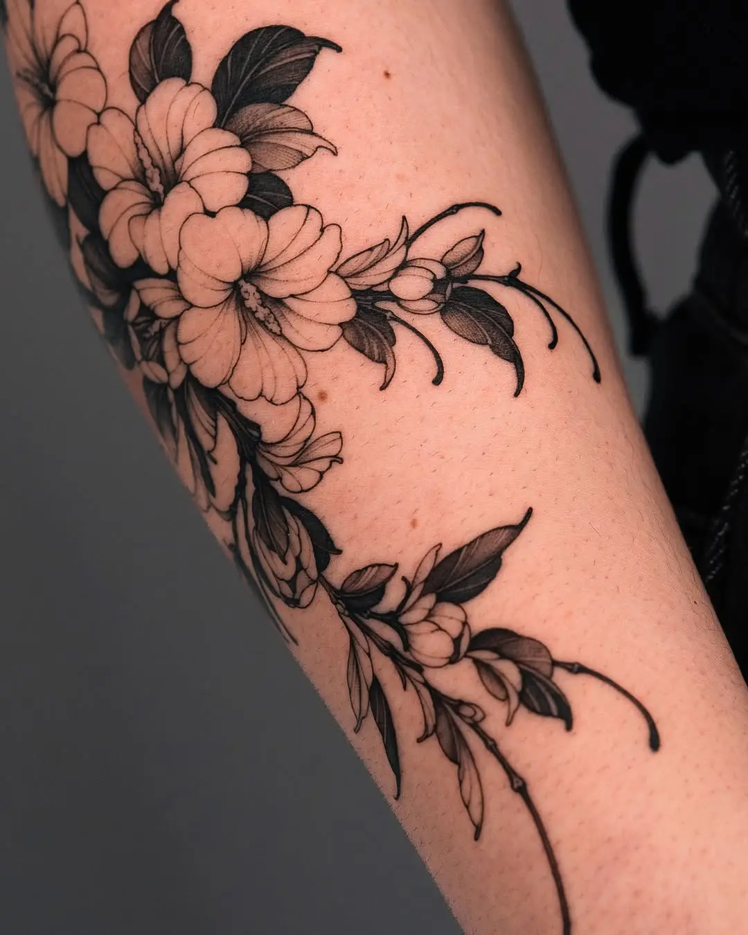 Elegant floral tattoo on the forearm