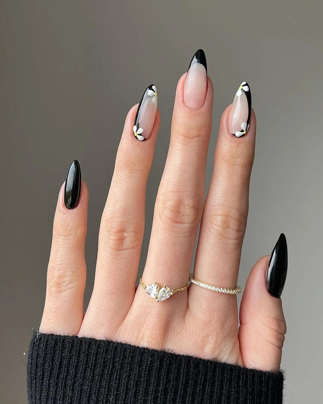 Chic black nails with floral accents and elegance