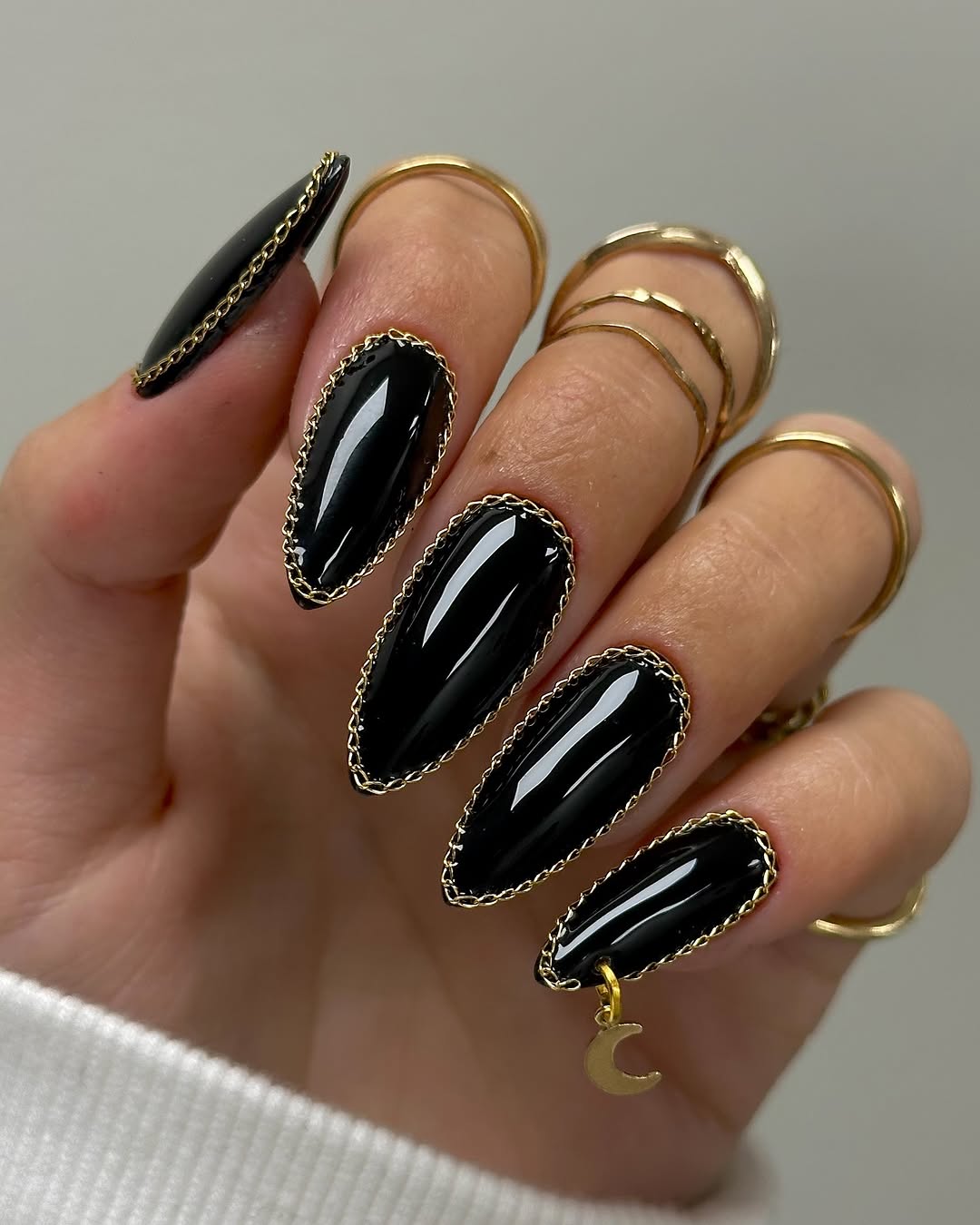 Chic stiletto black nails with gold accents