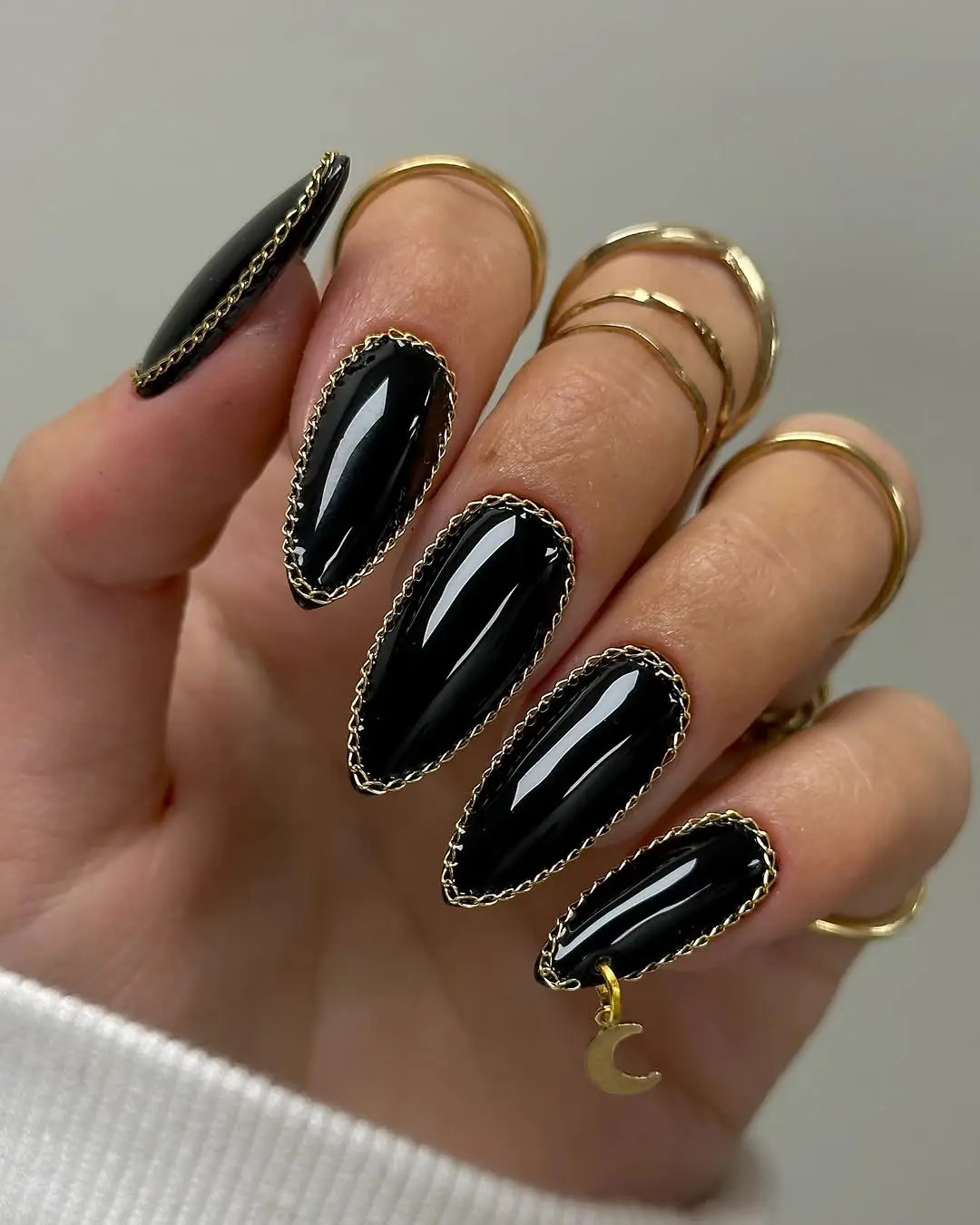 Chic stiletto black nails with gold accents