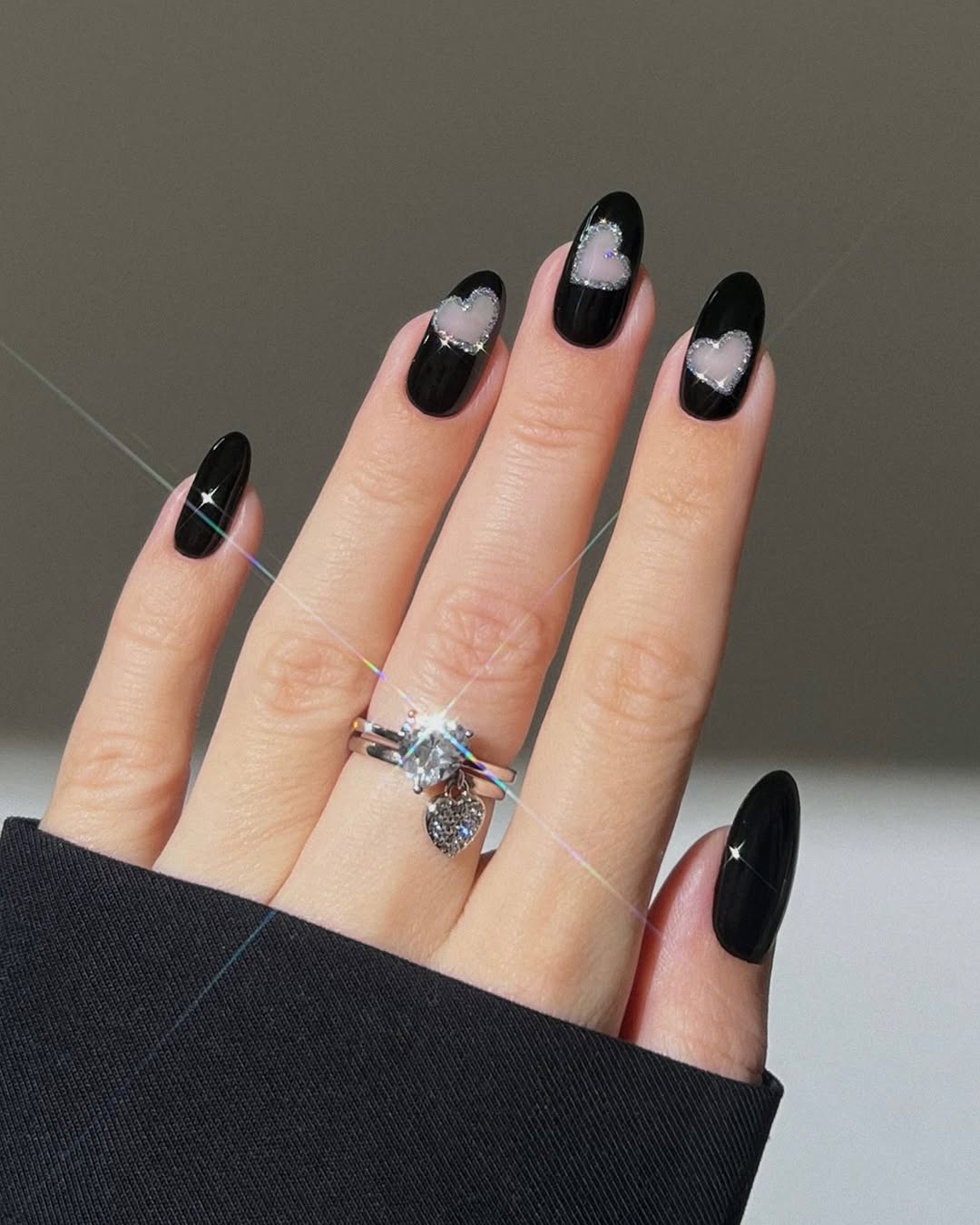 Stylish black nails with heart accents