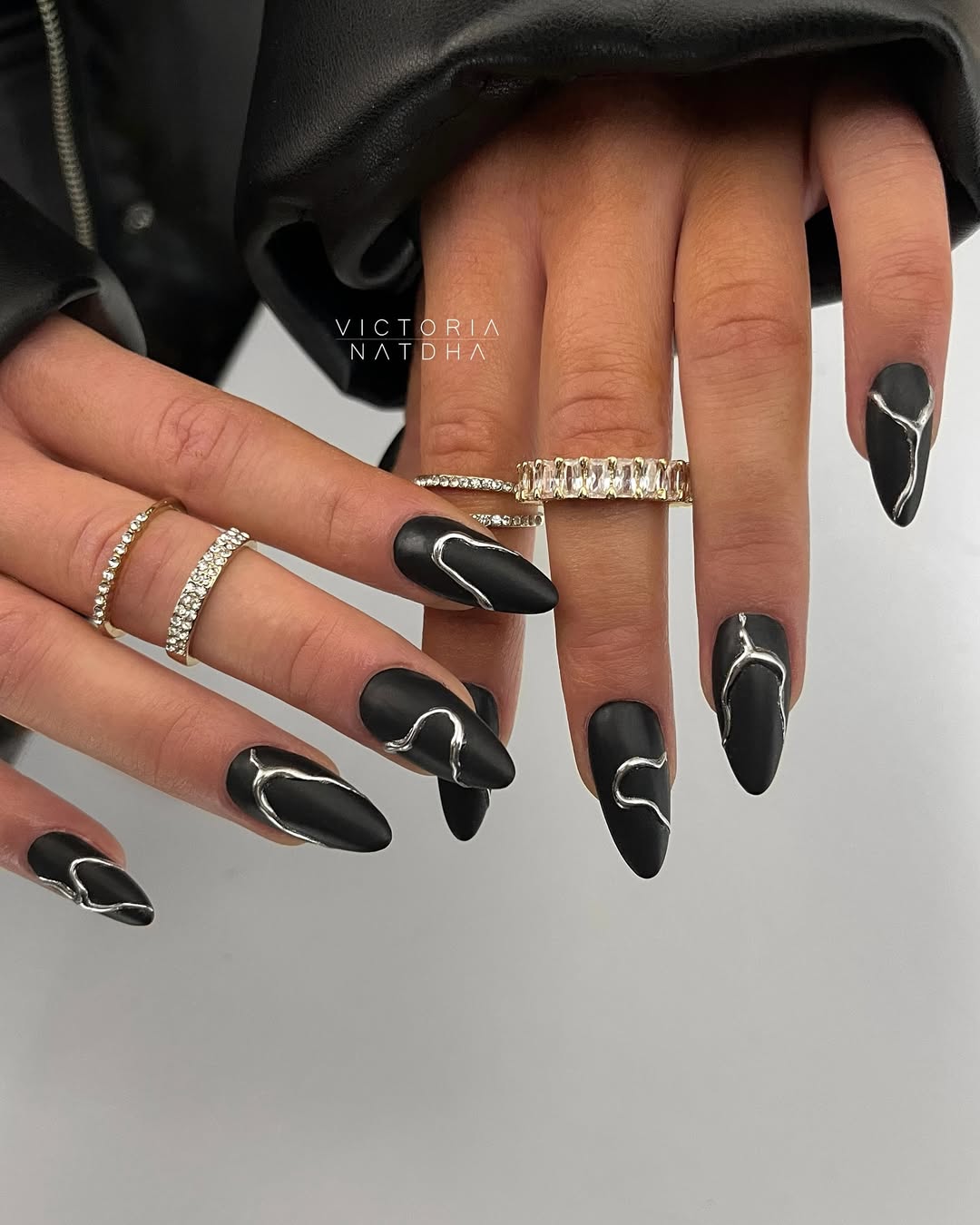 Stylish black nails with silver accents