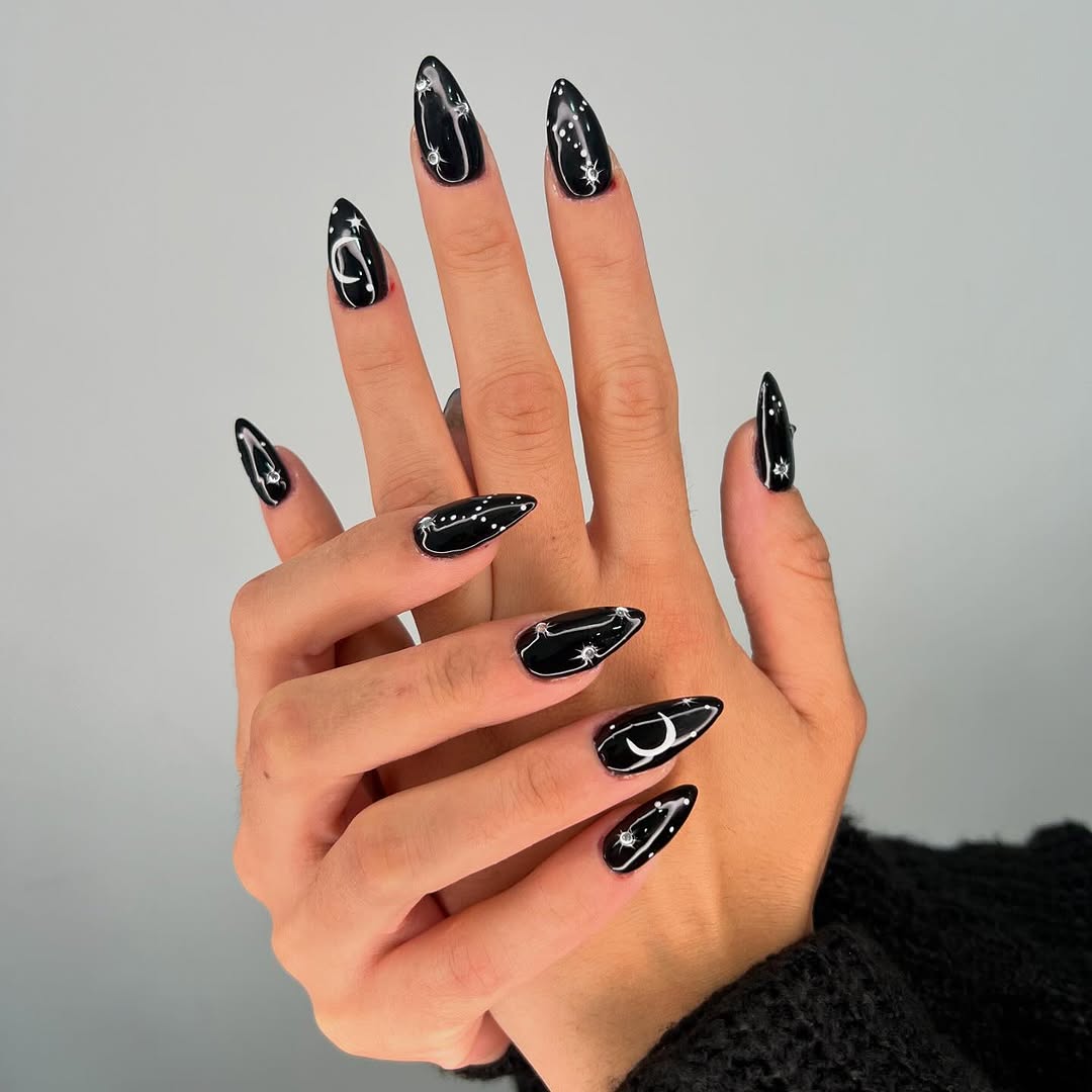 Elegant black nails with celestial designs