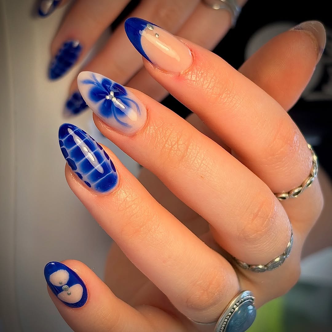 Vibrant blue nail art with floral accents
