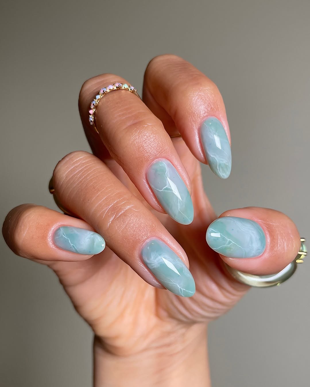 Elegant blue marbled nails with vibrant shine