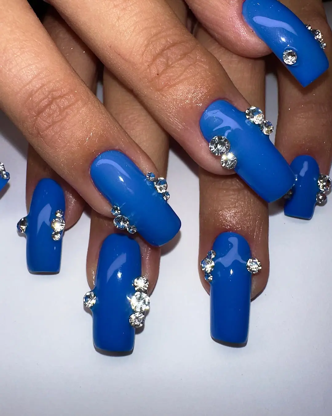 Gorgeous blue nails adorned with rhinestones