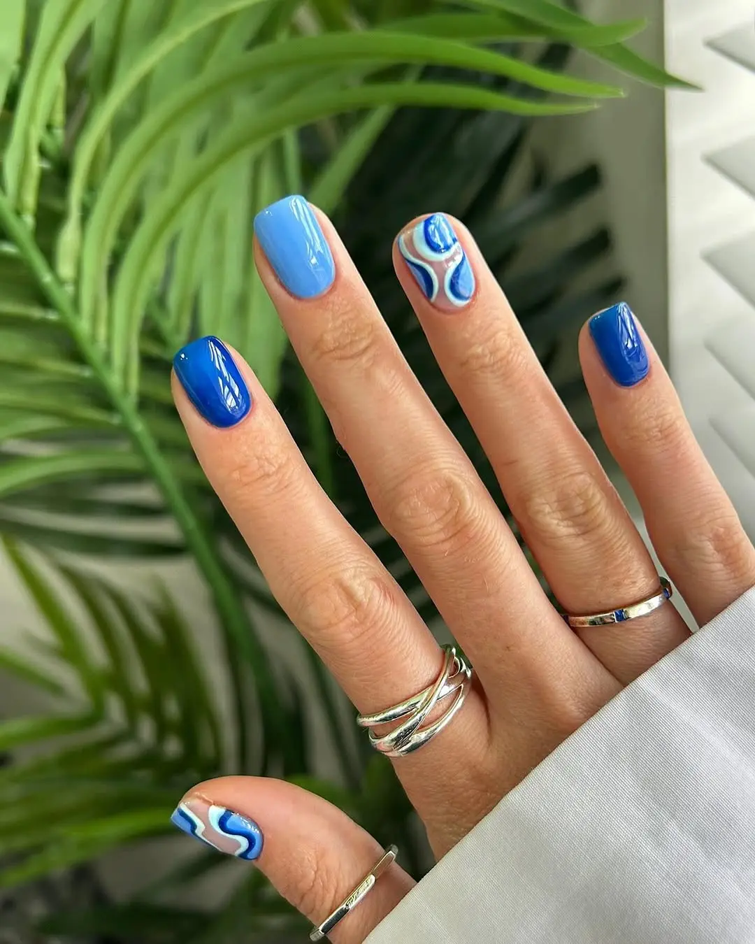 Stunning Blue Nail Art with Wave Patterns