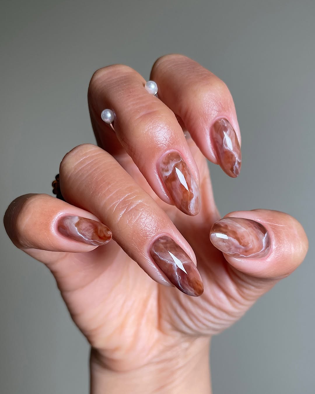 Stylish brown nail art with a marbled effect