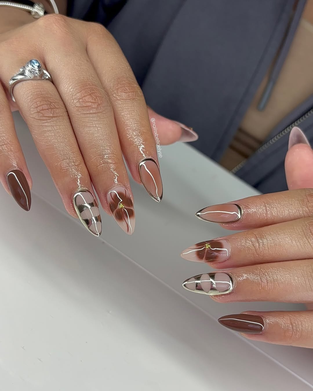 Stylish brown nails with intricate designs