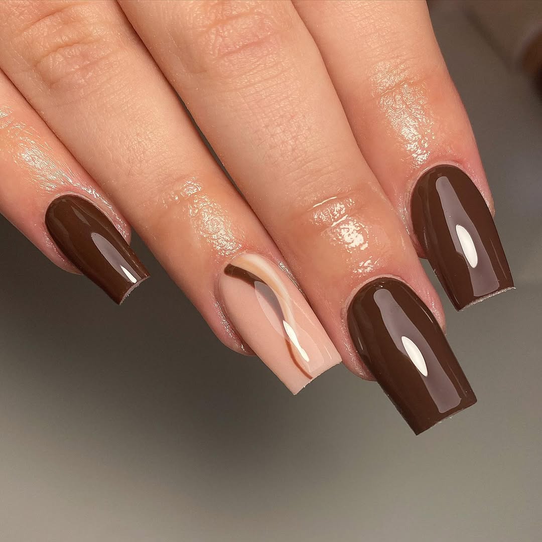 Stylish brown nails featuring glossy shapes
