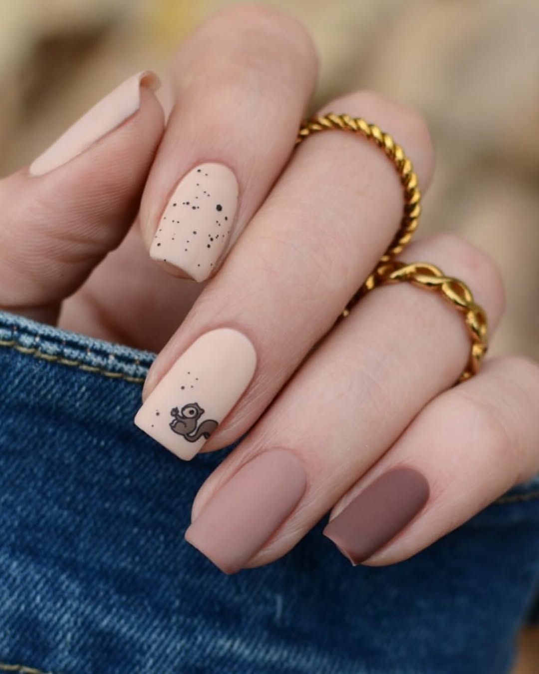 Chic brown nails with playful squirrel design