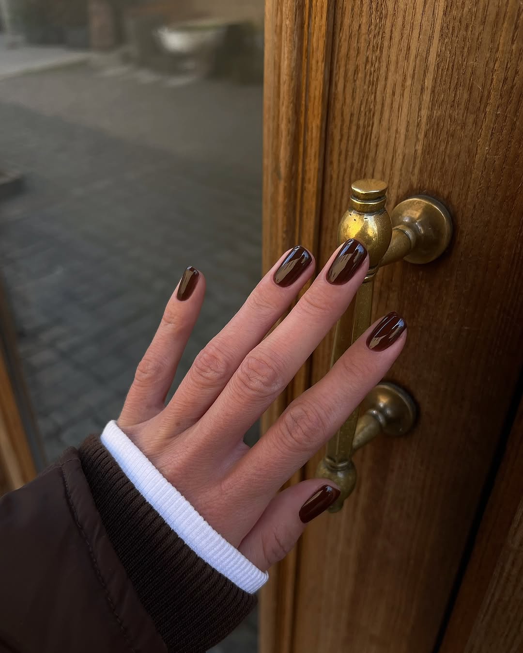 Stylish brown nails on a winter day