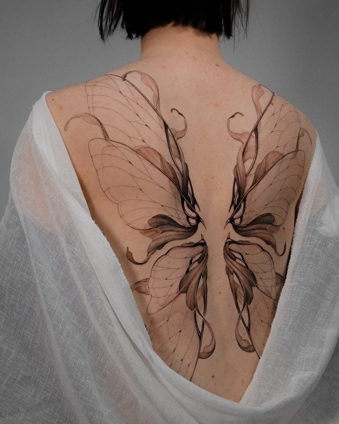 Elegant butterfly design on the back.
