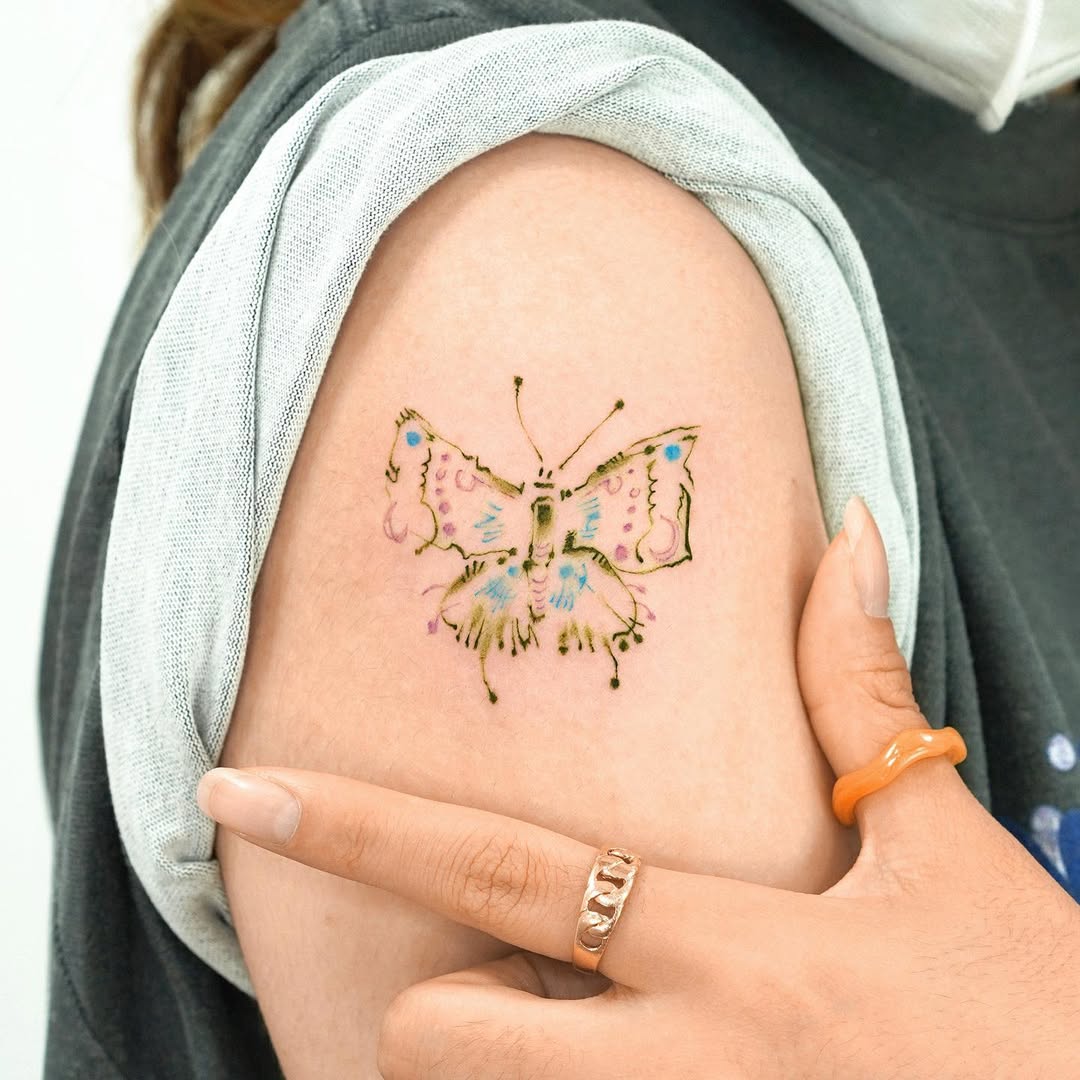 Colorful butterfly tattoo enhances shoulder style