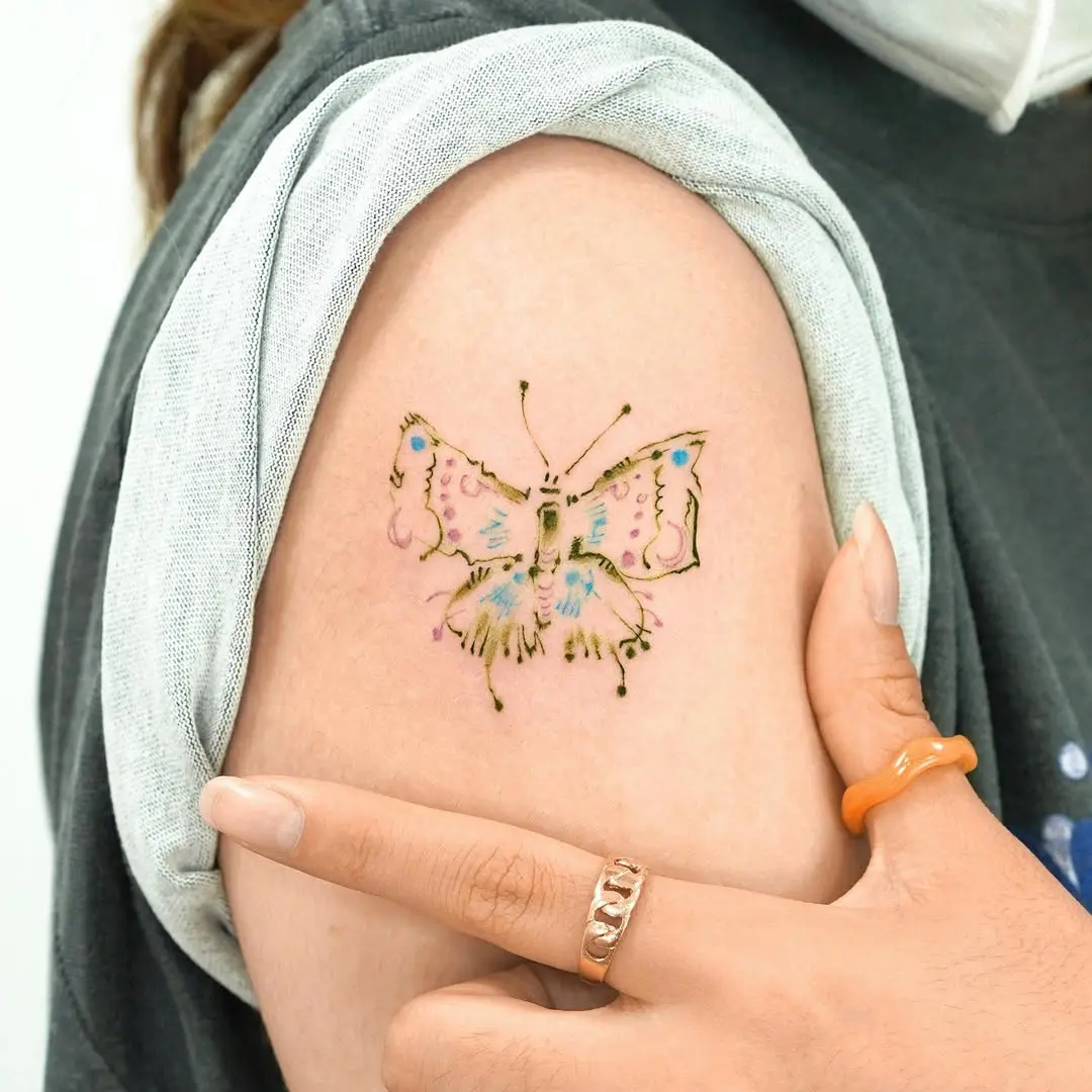 Colorful butterfly tattoo enhances shoulder style