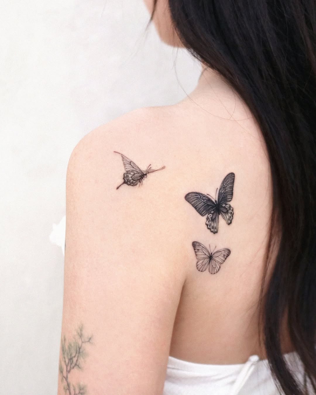 Delicate butterfly tattoos on shoulder elevate style