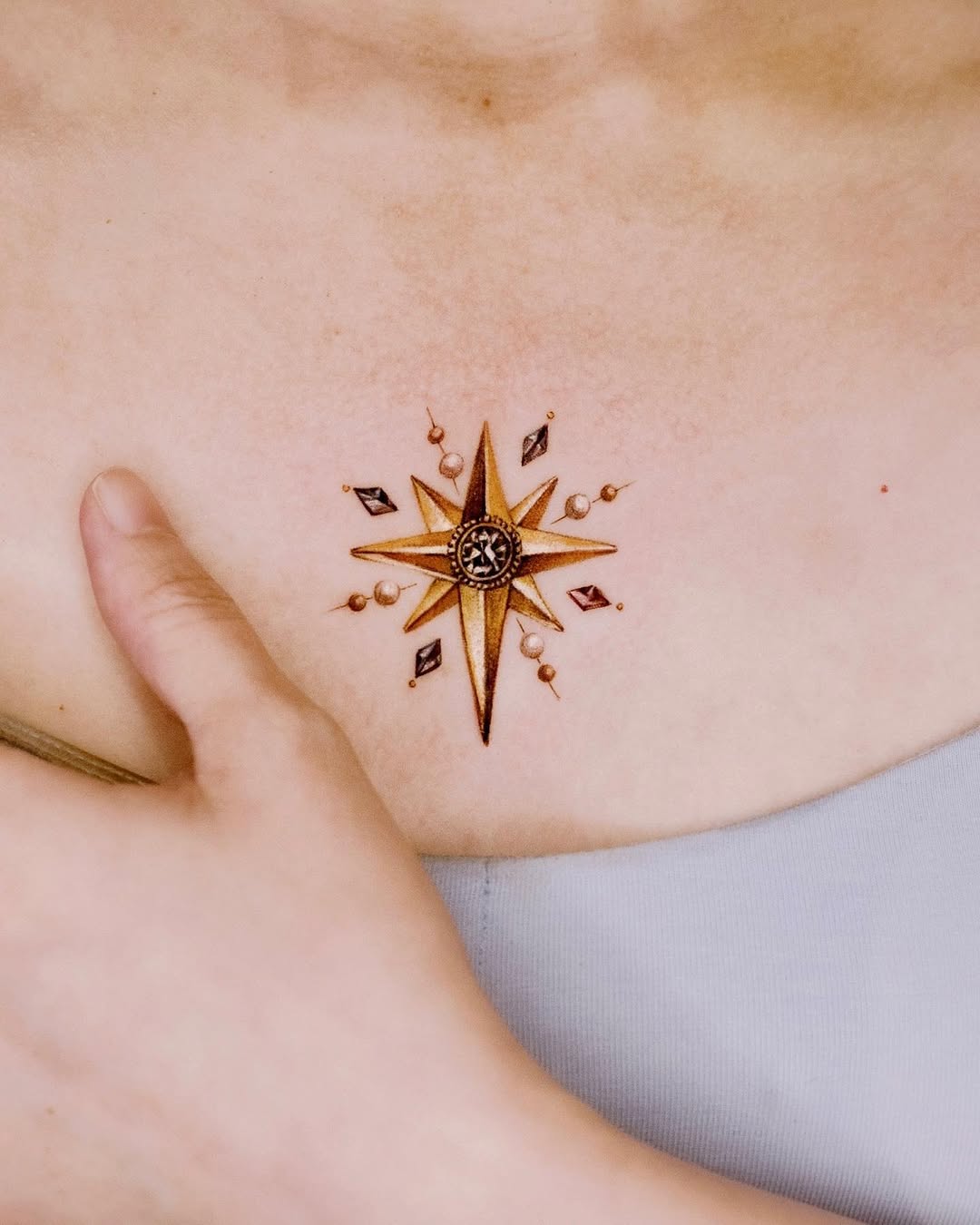 Intricate compass rose chest tattoo design