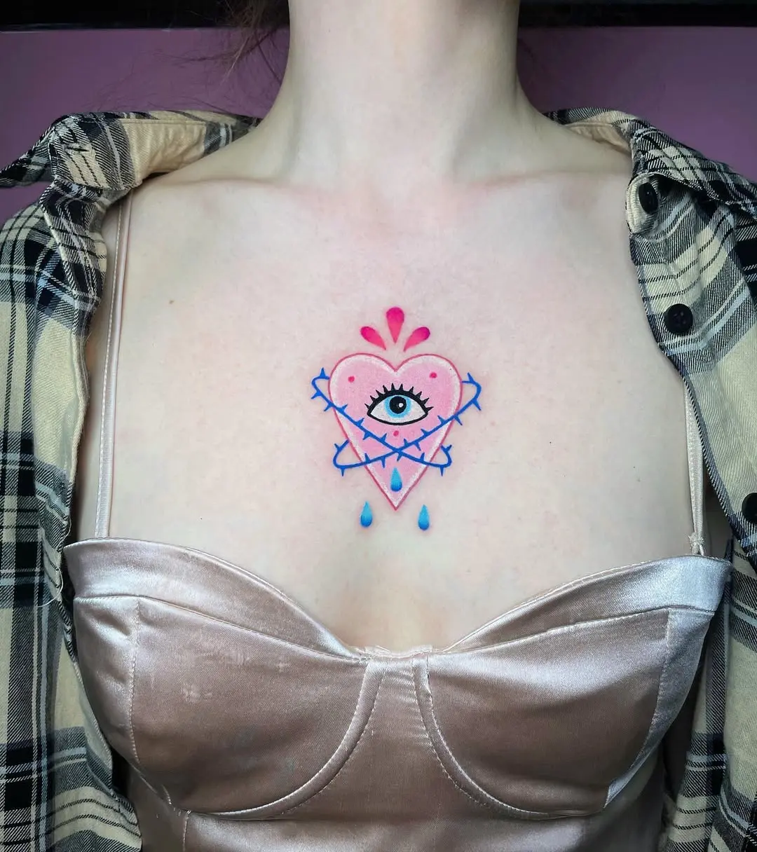 Colorful heart and eye chest tattoo design