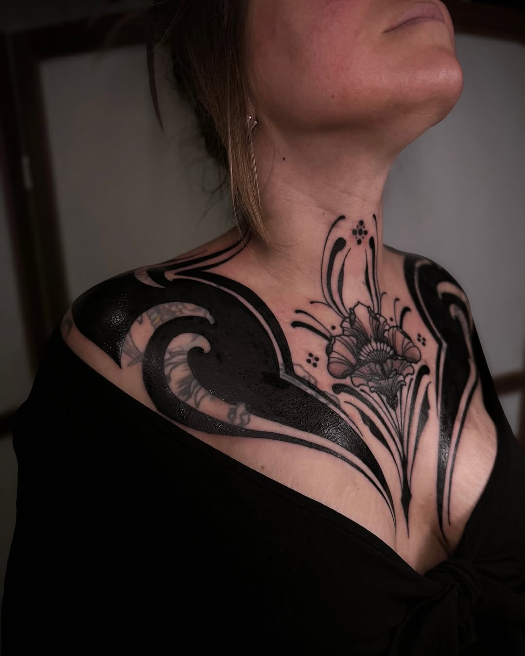 Elegant black floral chest tattoo design