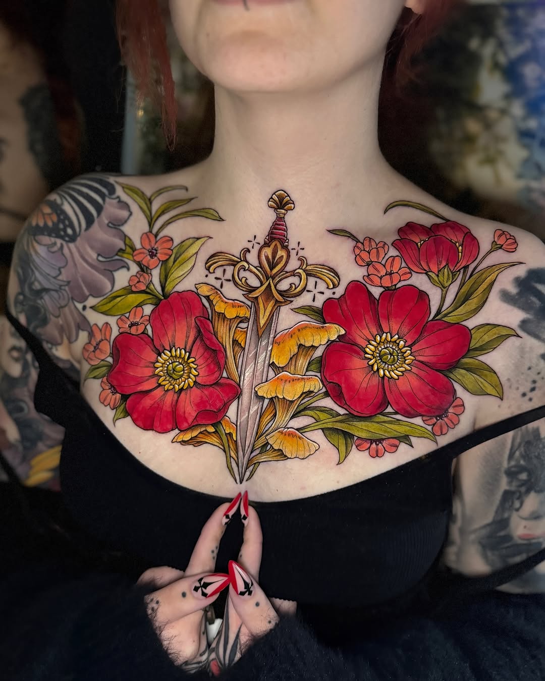 Floral and sword tattoo design on chest