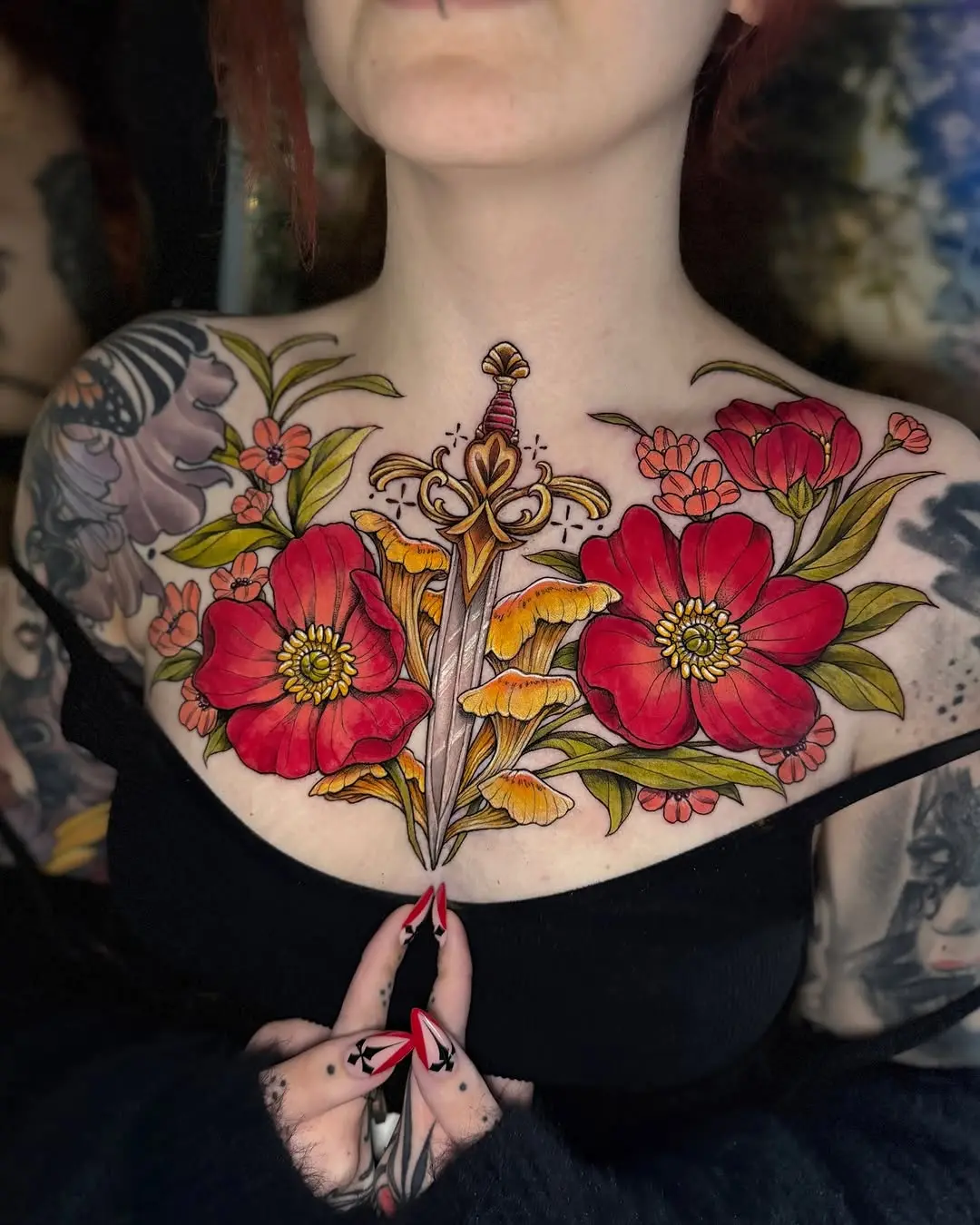 Floral and sword tattoo design on chest