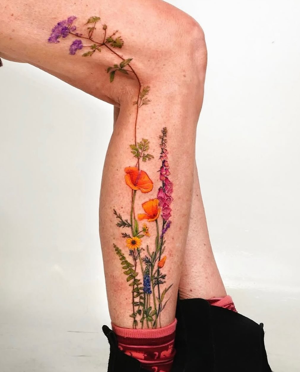 Vibrant floral leg tattoos exuding natural beauty