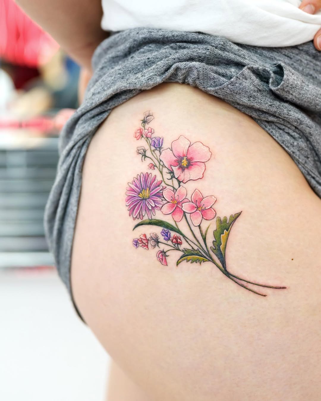 Vibrant Floral Thigh Tattoo for Unique Style