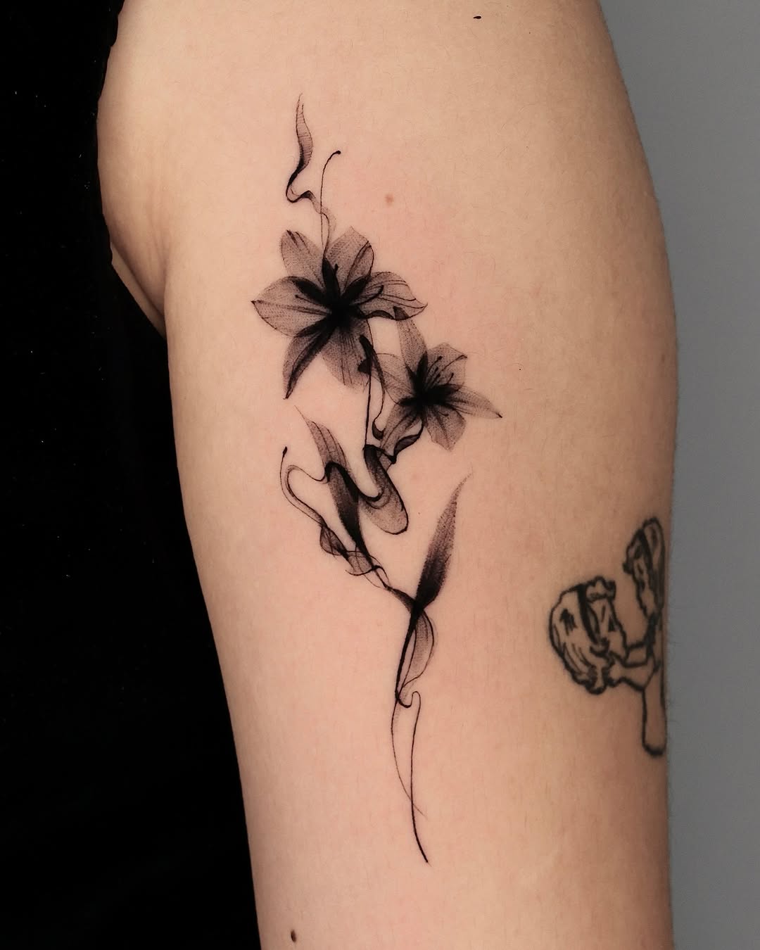 Elegant black ink flower tattoo design