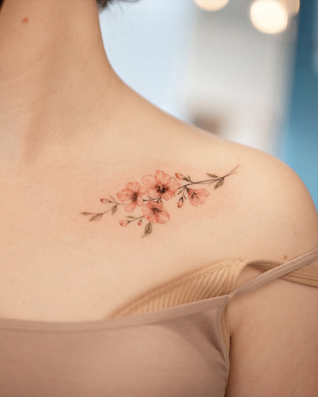 Delicate flower tattoo gracing the shoulder