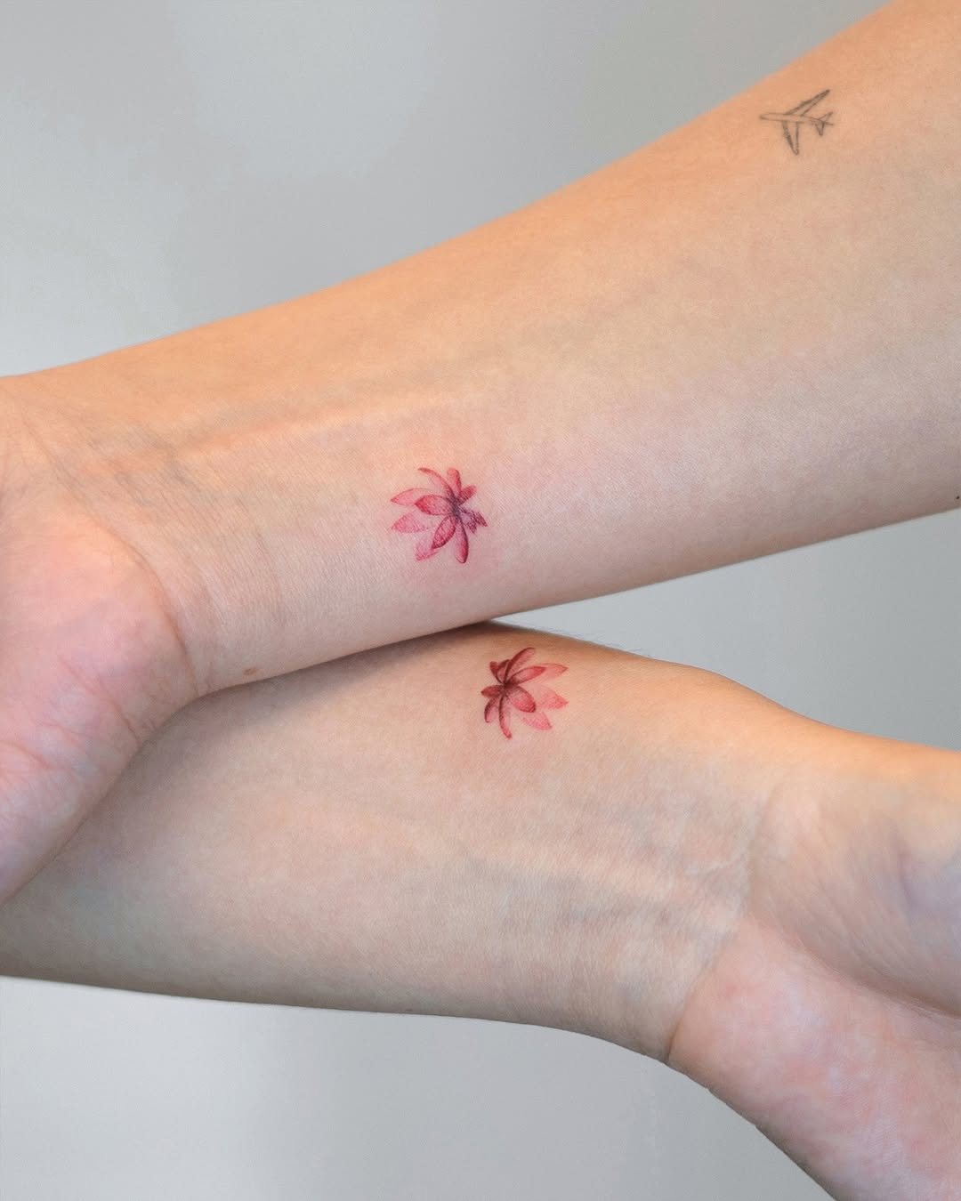 Delicate floral tattoos on graceful forearms