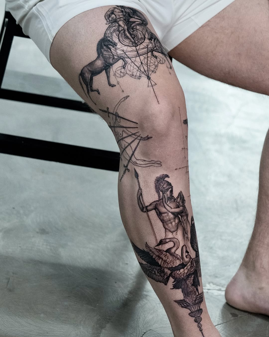 Intricate black and gray leg tattoo design