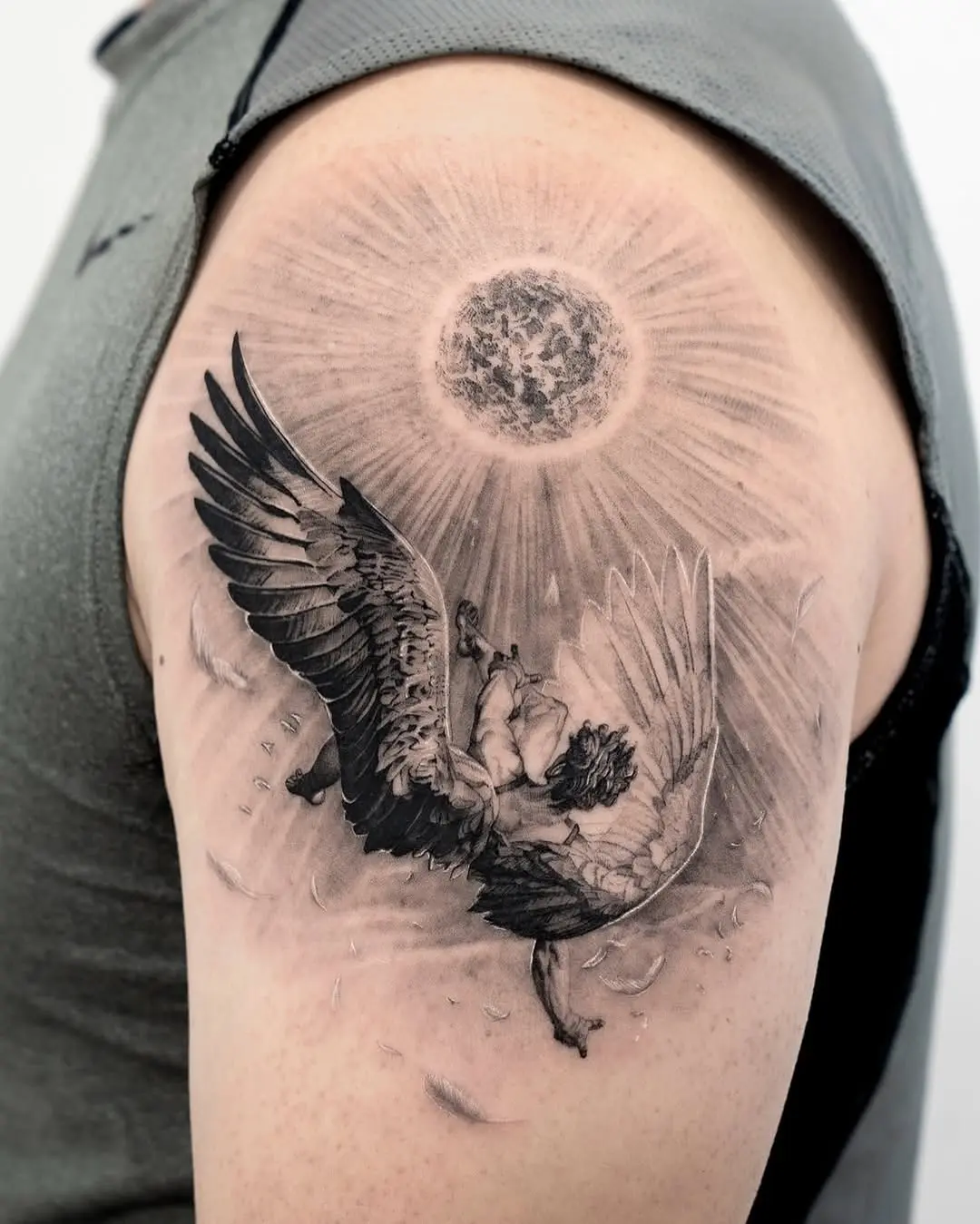 Dramatic winged figure under radiant sun.