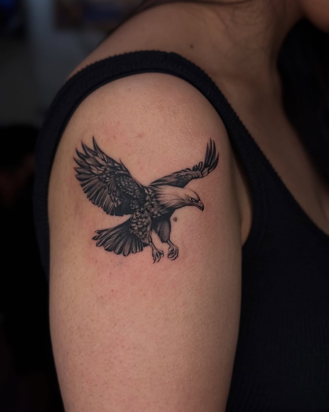 Majestic eagle in flight adorns shoulder.