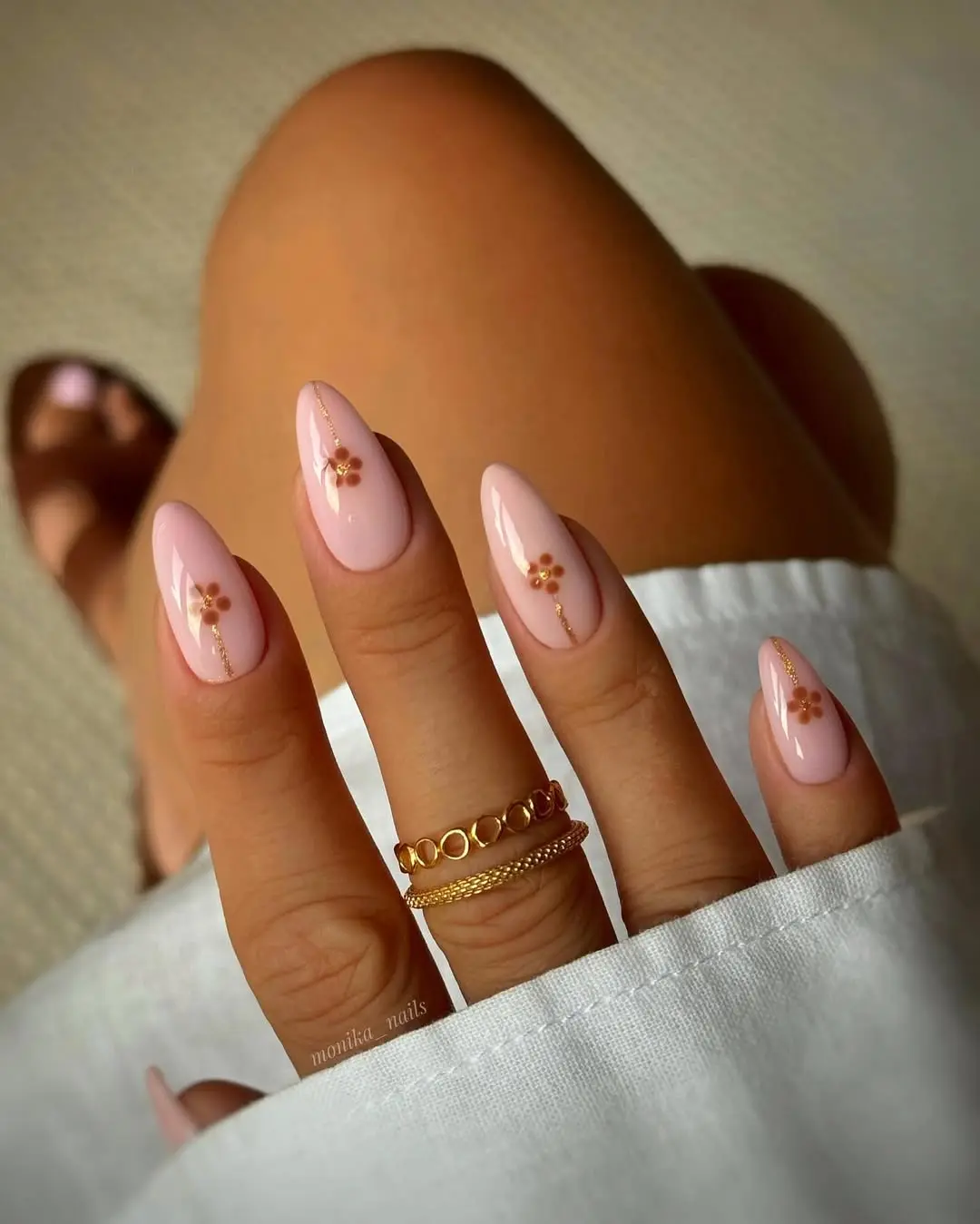 Chic beige nails with delicate floral accents