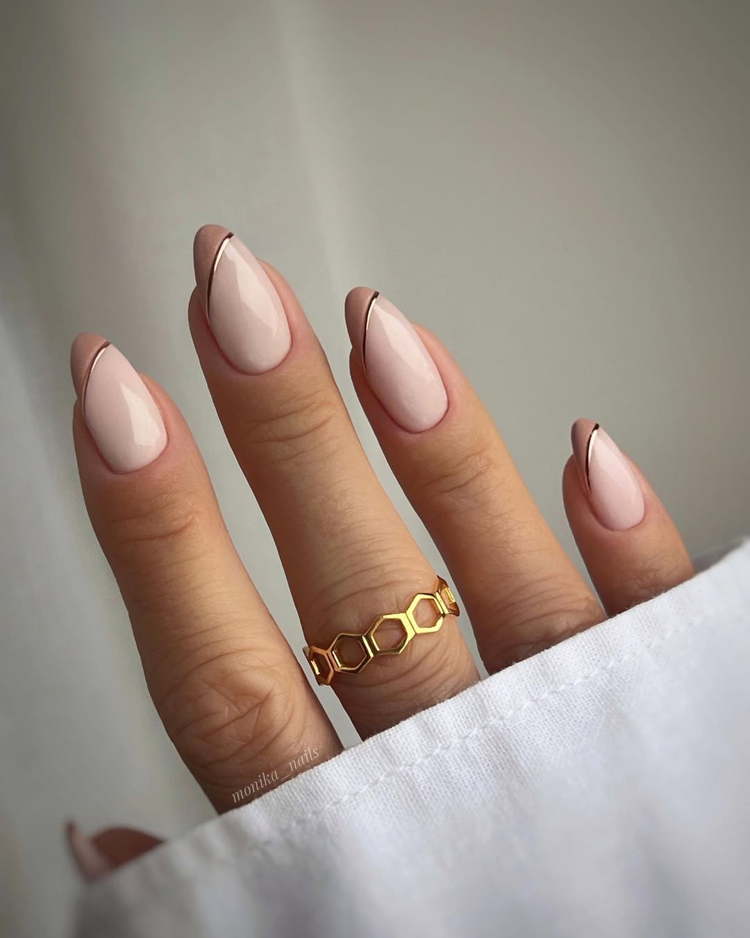 Elegant beige nails with chic gold accents