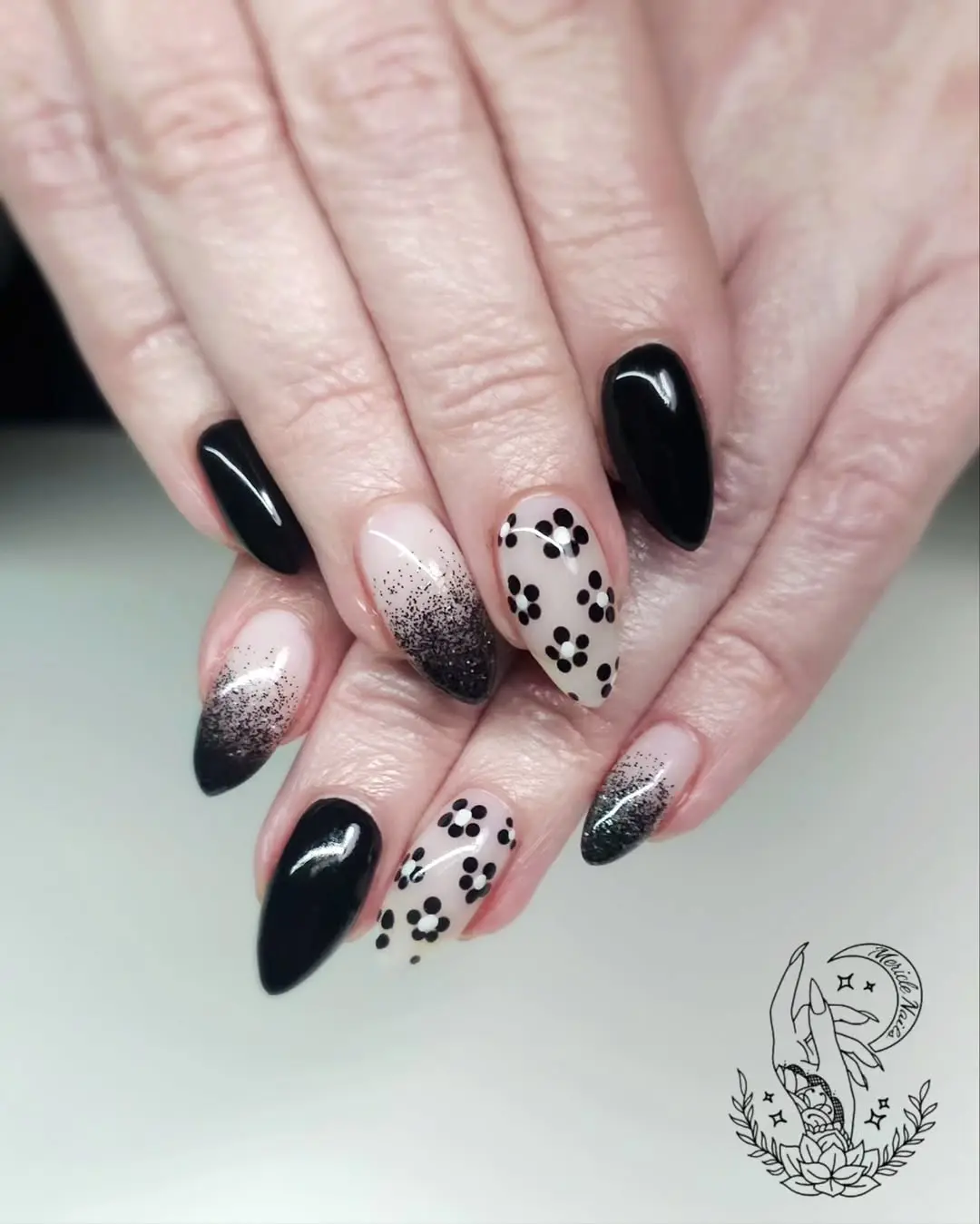 Stunning black nail art with floral designs