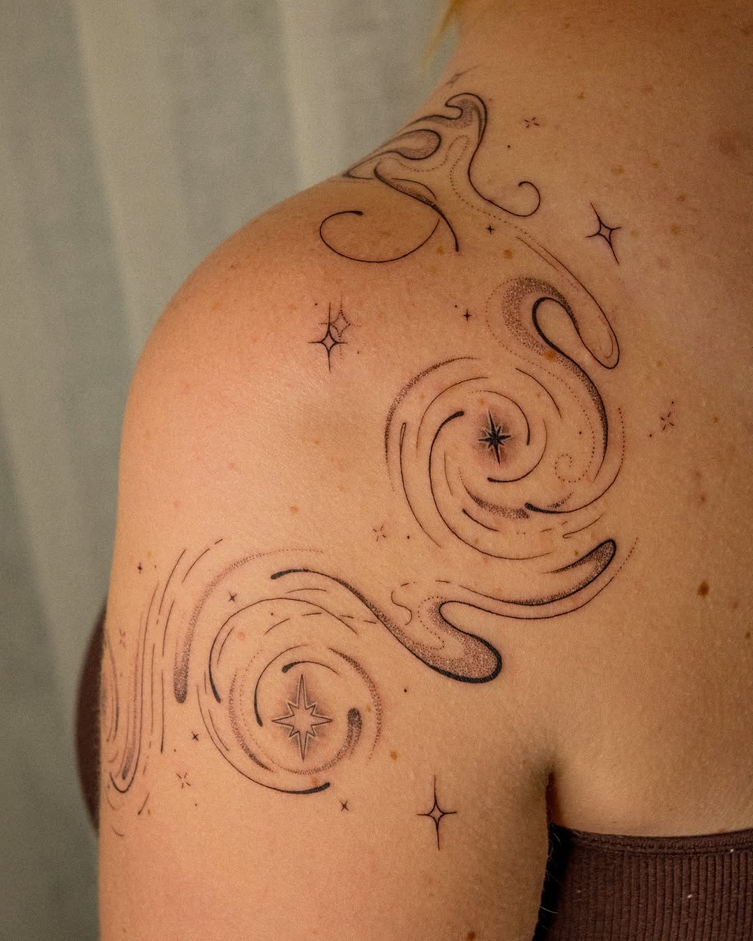 Intricate swirl tattoo with celestial accents