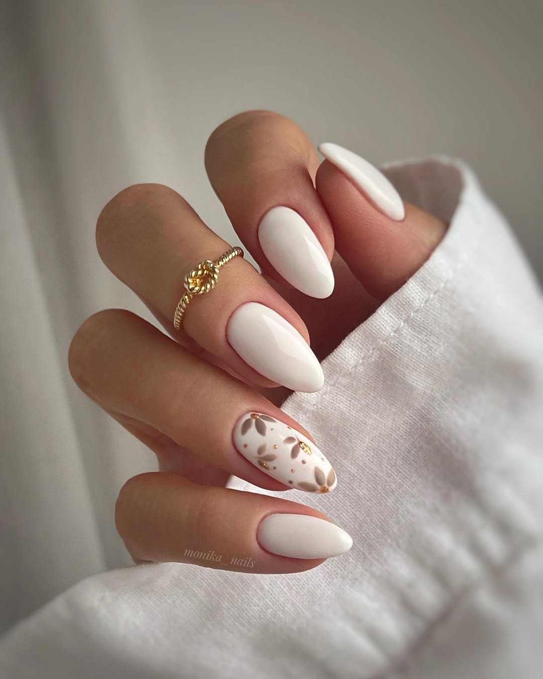 Chic white nails with a subtle gold touch