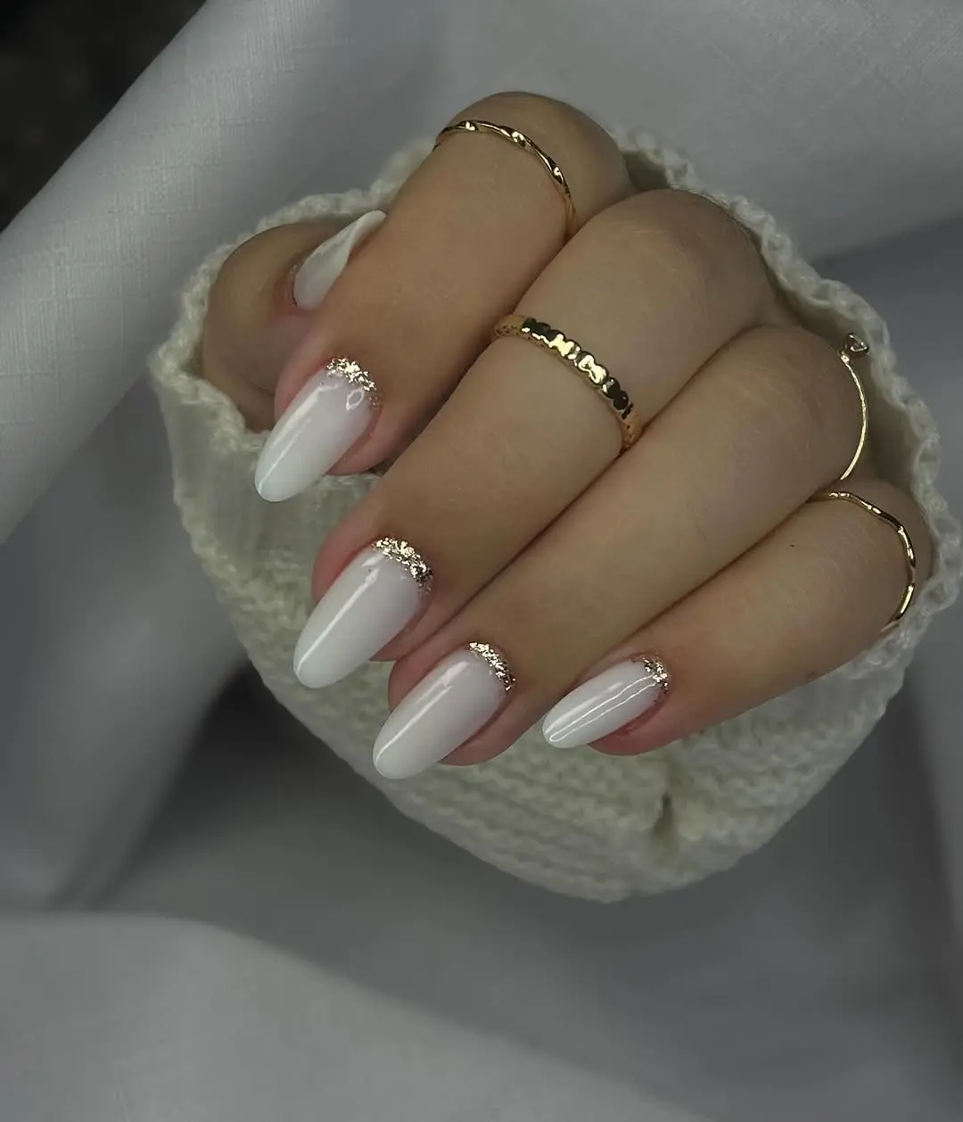 Elegant white nails layered with golden accents