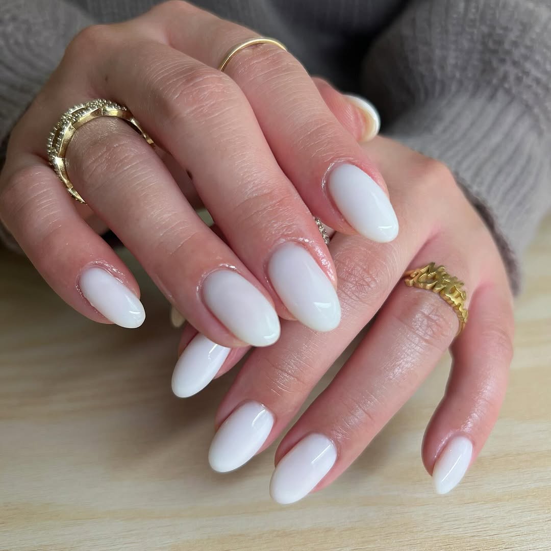 Chic and sleek white nails with golden accents