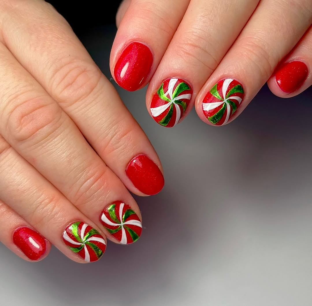 Vibrant red nails with festive swirl designs