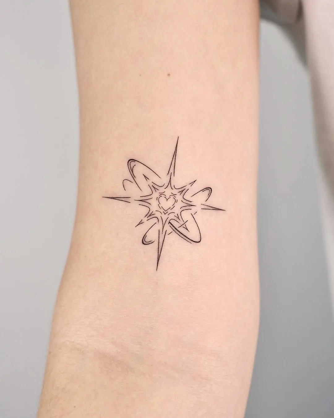 Chic Fine Line Starburst Tattoo Design