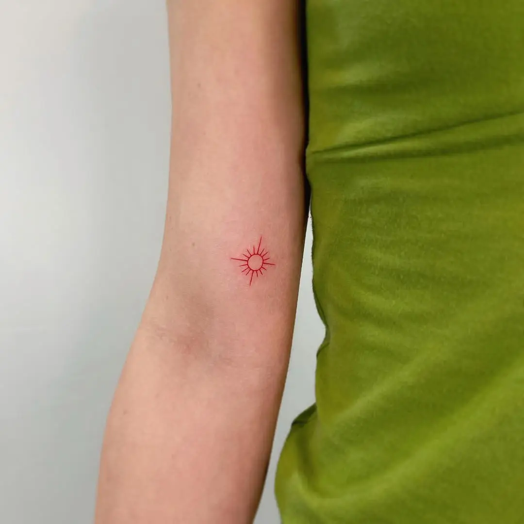 Minimalistic sun tattoo radiating vibrant energy
