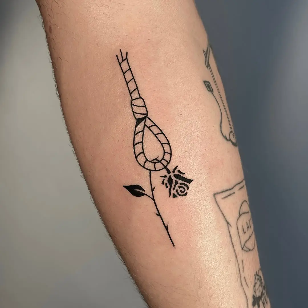 Minimalistic tattoo featuring a delicate rose