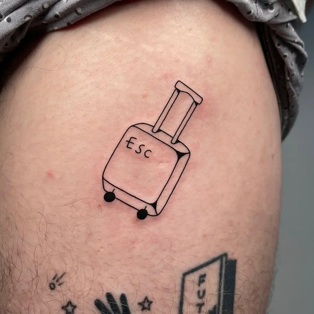 Whimsical suitcase tattoo for adventure lovers