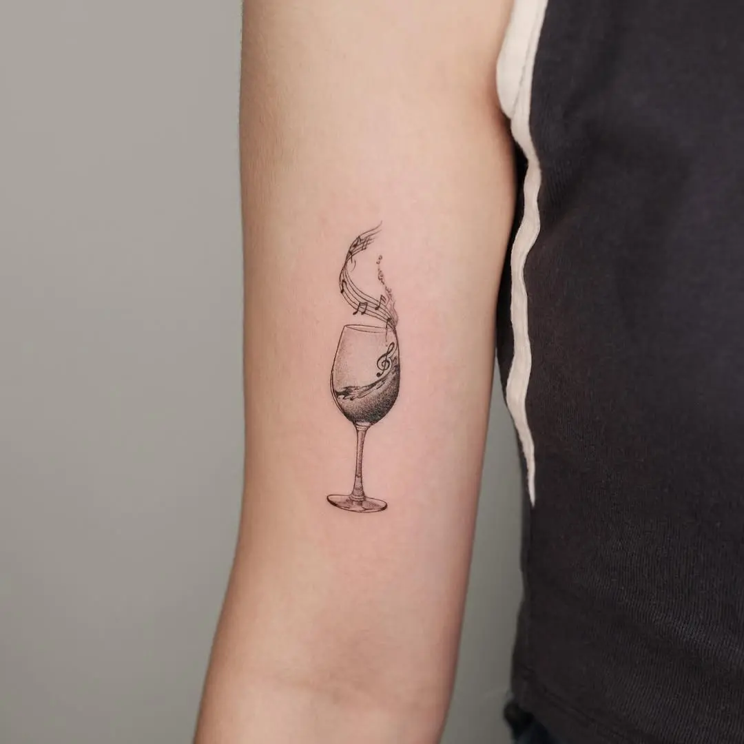 Elegant fine line wine glass tattoo design